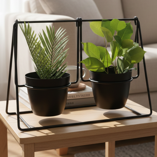 Two potted plants on a wooden table with a sofa in the background