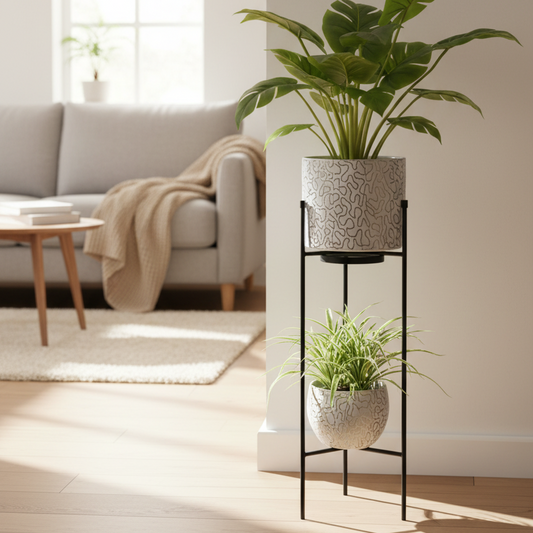 Two potted plants on a black metal plant stand against a white background