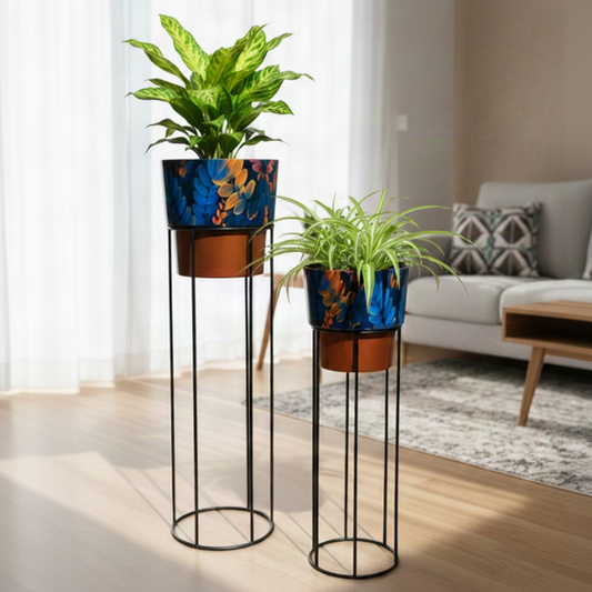 Two decorative plant stands with potted plants in a living room setting.