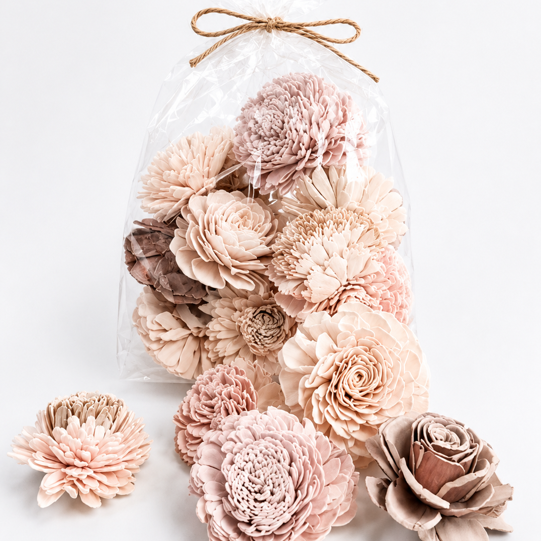 Decorative wall art with pink and beige flowers in a clear bag on a white background