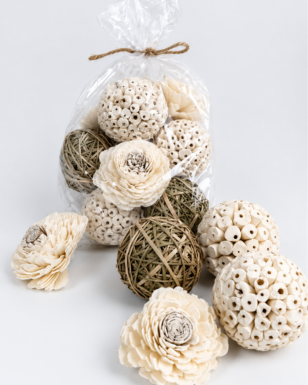 Decorative items including spherical balls and flowers in a clear plastic bag on a light background
