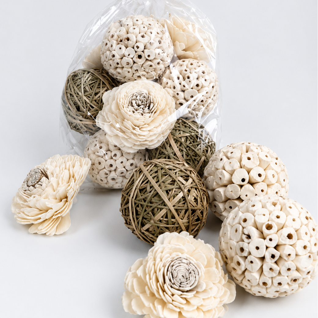 Decorative items including spherical balls and flowers in a clear plastic bag on a light background