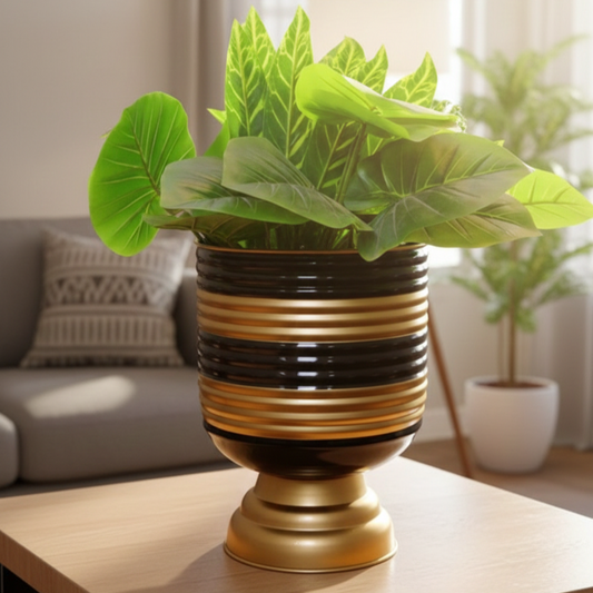 Decorative plant in a gold pot on a table with a living room background