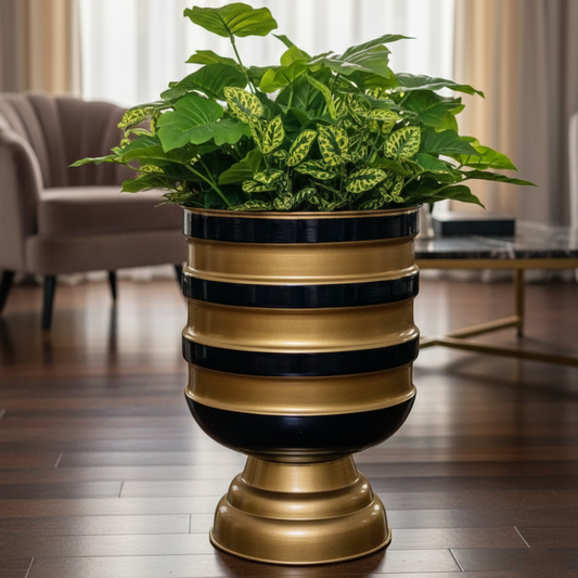 Decorative gold and black planter with a green plant in a living room setting.