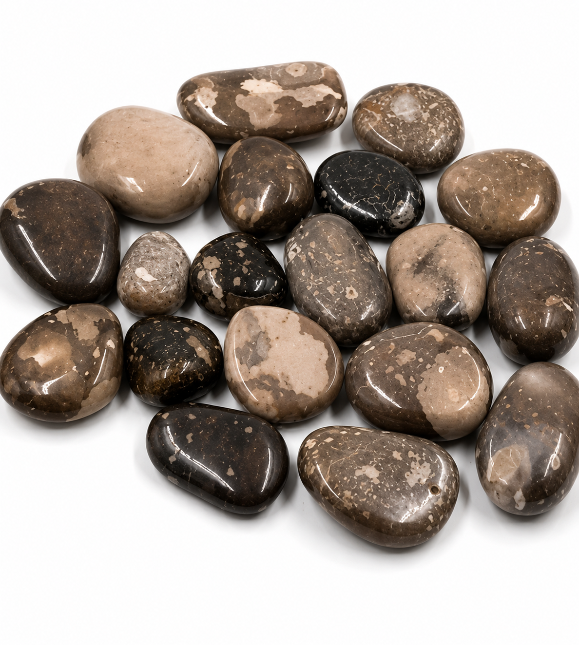 Assorted brown and black stones on a white background