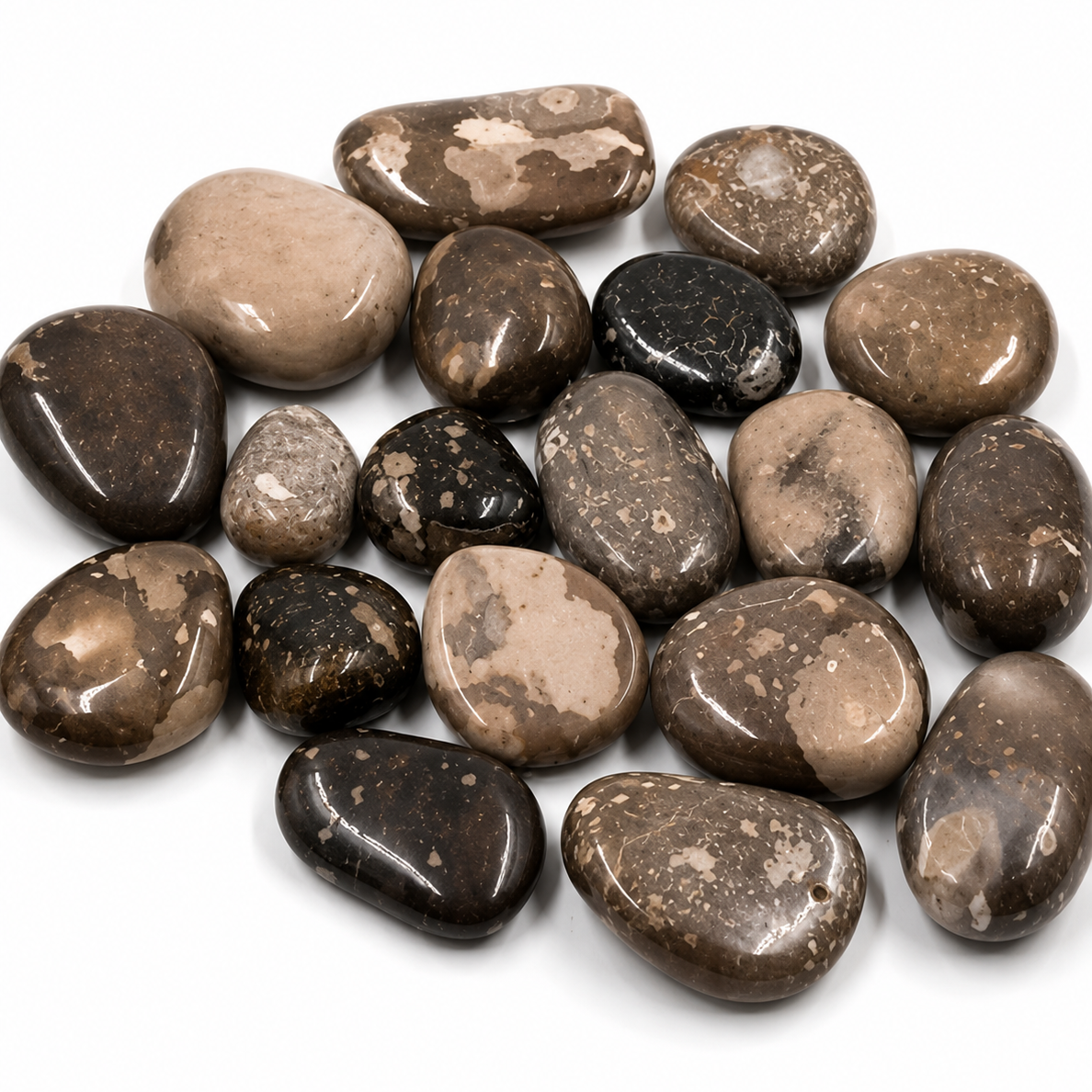 Assorted brown and black stones on a white background