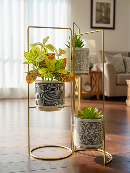 Gold plant stand with three potted plants in a living room setting