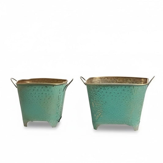 Two turquoise metal planters with gold accents on a white background