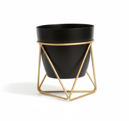 Black planter with gold geometric stand on a white background