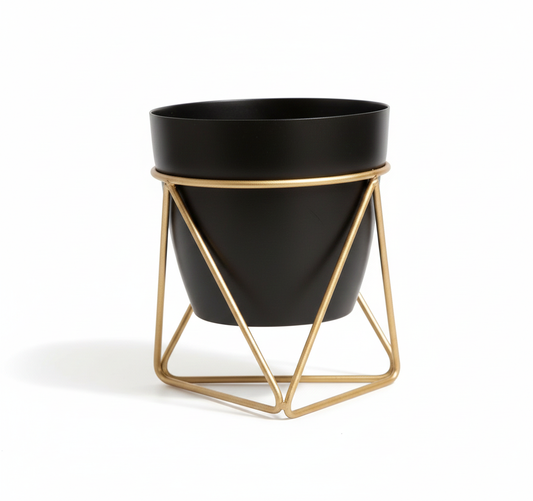 Black planter with gold geometric stand on a white background