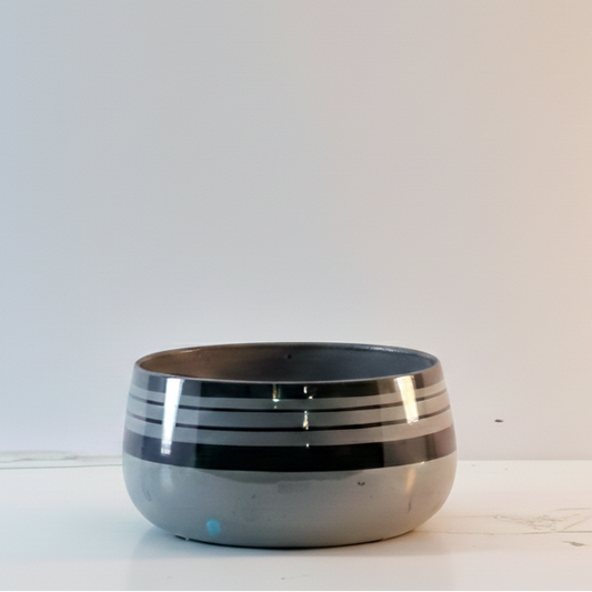 Ceramic bowl with black interior on a white background