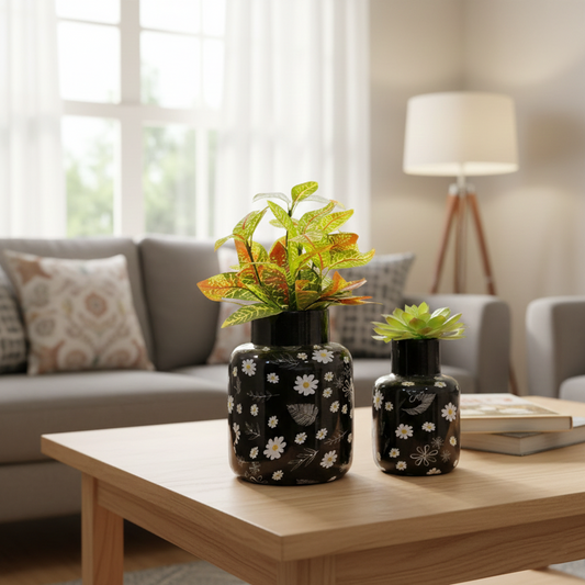 Two decorative vases with plants on a wooden coffee table in a living room.