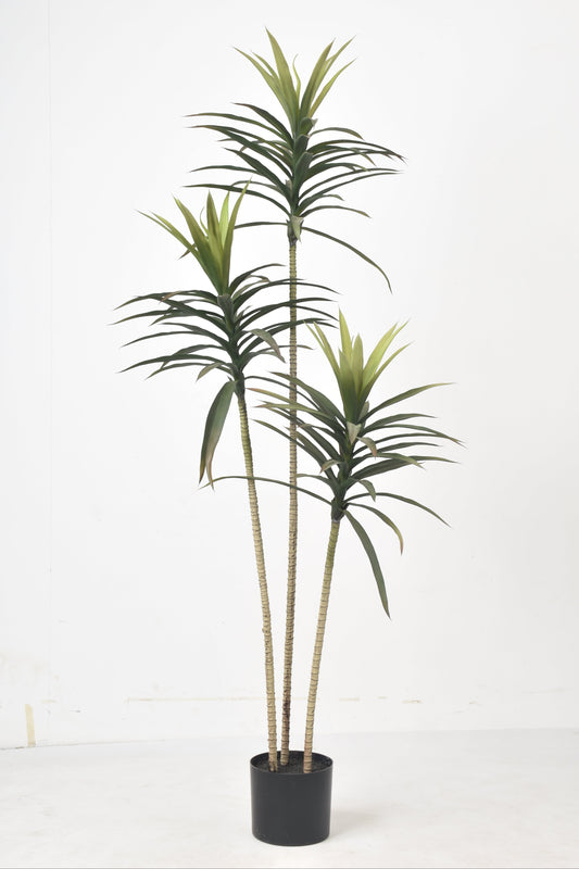 Artificial plant with green leaves in a black pot on a white background