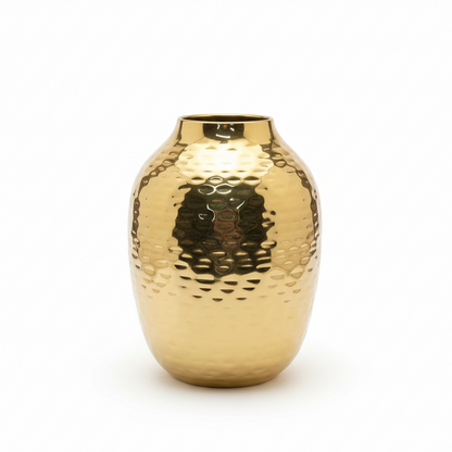 Gold metallic vase with a textured surface on a white background
