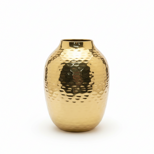 Gold metallic vase with a textured surface on a white background