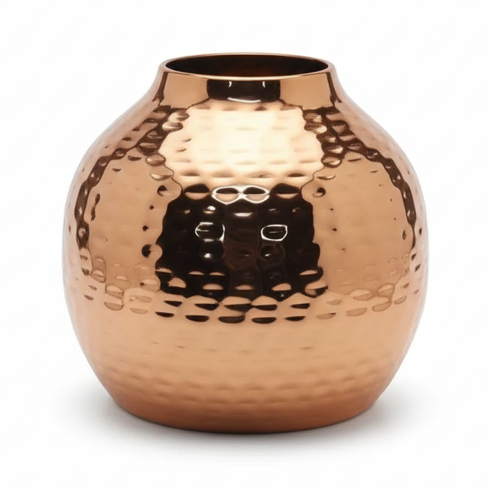 Copper vase with a textured surface on a white background