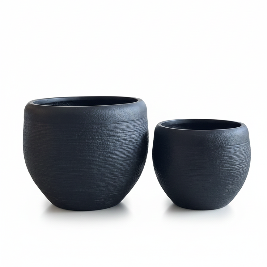 Two dark gray ceramic planters on a white background