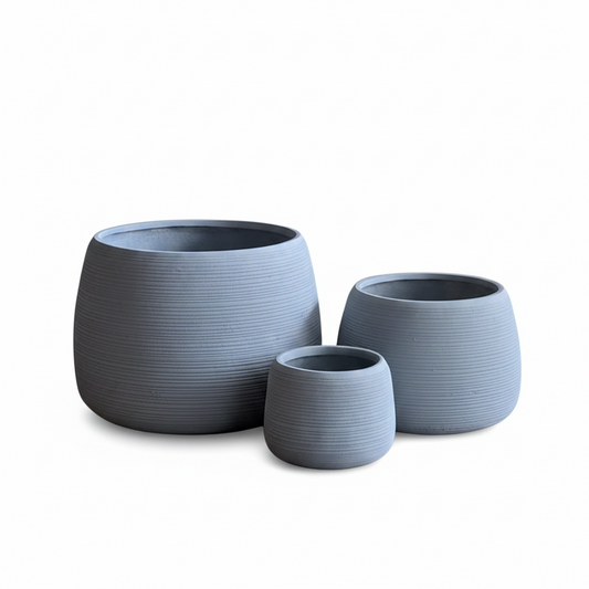 Three gray textured planters of different sizes on a white background