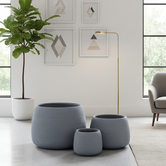 Set of gray planters with a green plant in a modern living room.