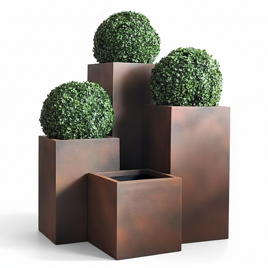 Set of three copper planters with spherical green plants on a white background