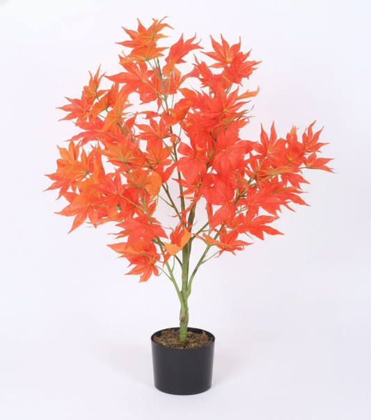 Potted artificial plant with orange leaves on a white background