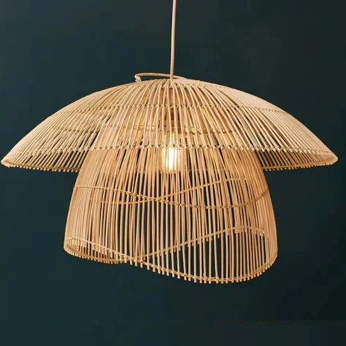 Woven rattan pendant light against a dark background
