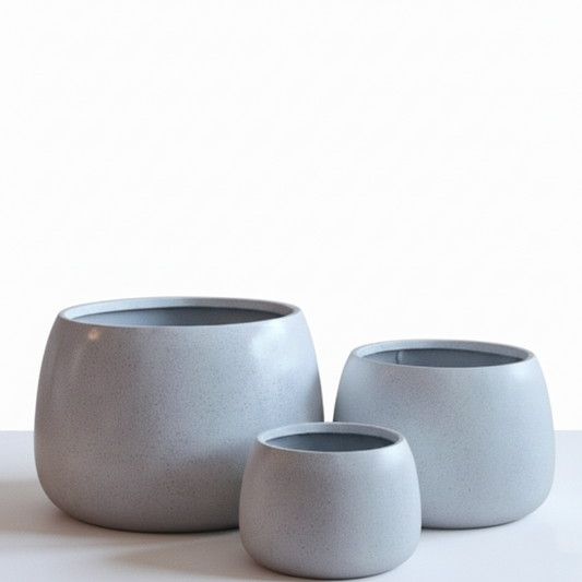 Three gray ceramic planters of different sizes on a white background