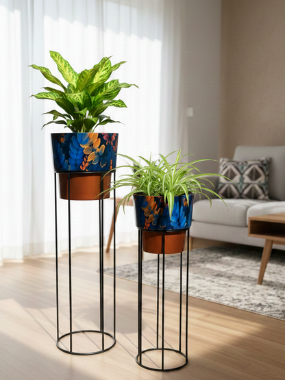Two decorative plant stands with potted plants in a living room setting.