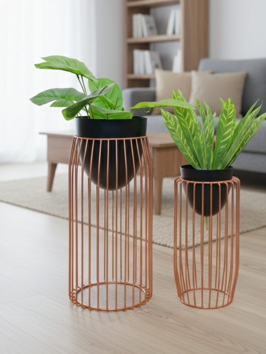 Two wire plant stands with potted plants in a living room setting.