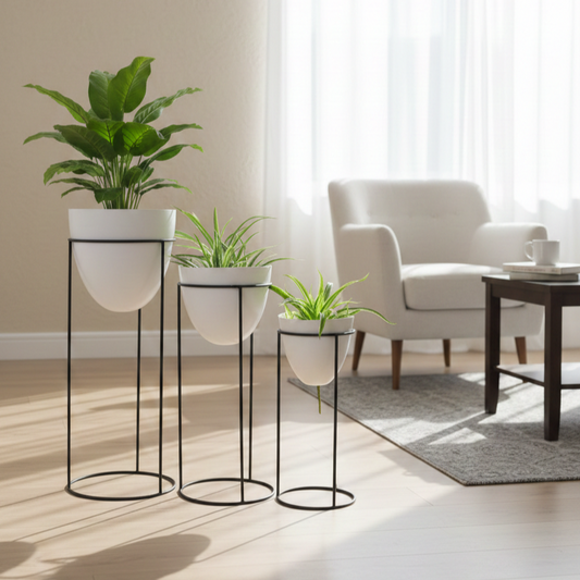 Modern living room with white armchair, coffee table, and decorative plants on black stands.