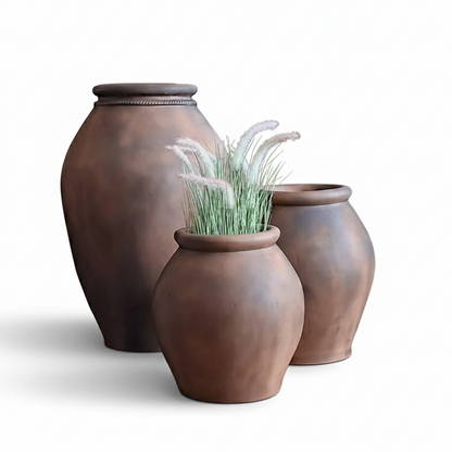 Three brown ceramic pots on a white background