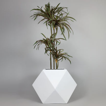 Geometric white planter with a potted plant on a gray background