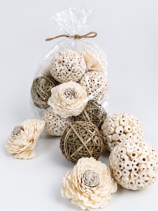 Decorative items including spherical balls and flowers in a clear plastic bag on a light background