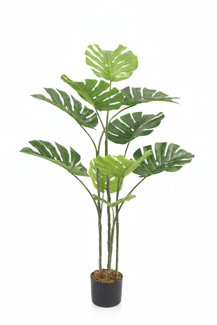 Potted artificial monstera plant on a white background