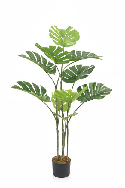 Potted artificial monstera plant on a white background