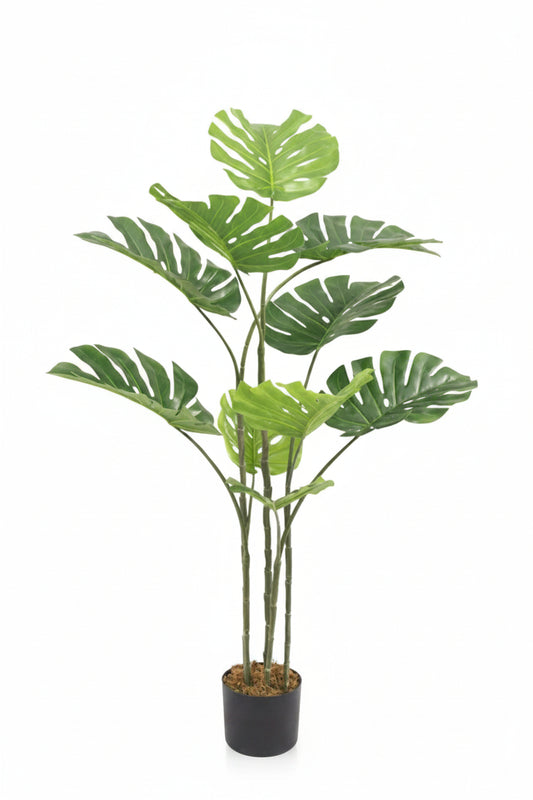 Potted artificial monstera plant on a white background