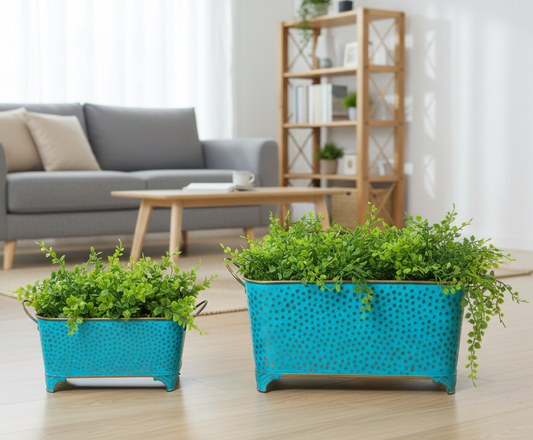 Two turquoise planters with green plants on a wooden floor in a living room.
