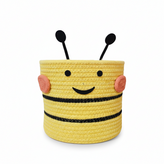 Yellow bee-shaped basket with black stripes and pink cheeks on a white background