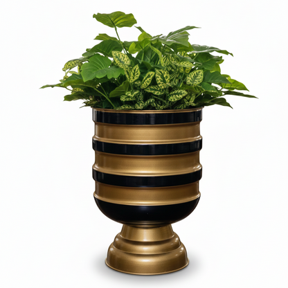Decorative planter with striped design and green plants on a white background