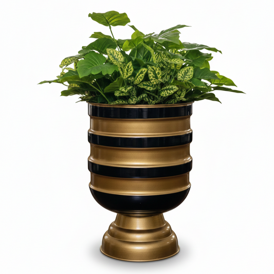 Decorative planter with striped design and green plants on a white background